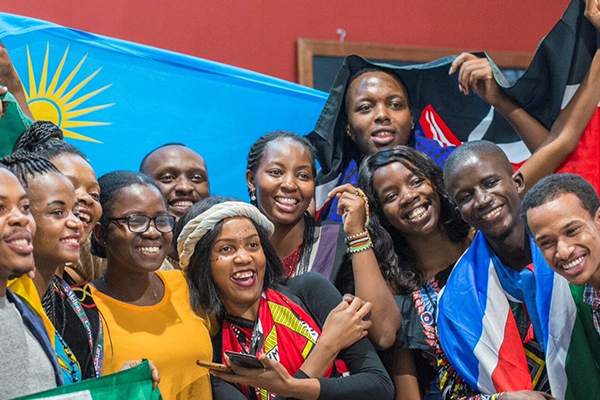 Group photo of students with their country flags