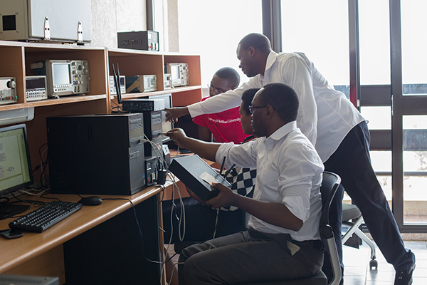 students working together around a computer