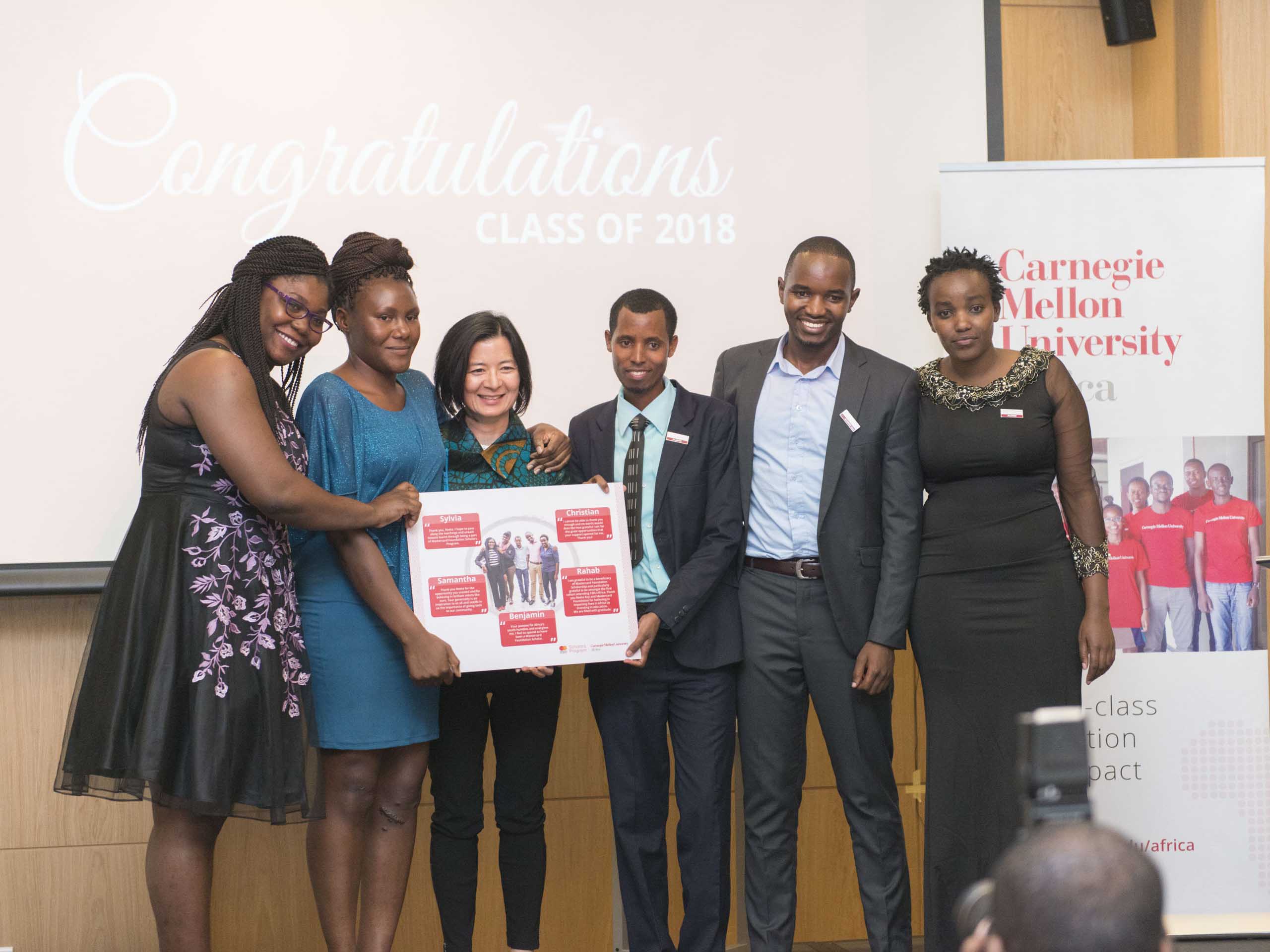 Scholars present their token of appreciation to Reeta Roy (centre)