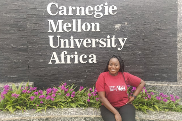 Ayobami at the CMU-Africa sign