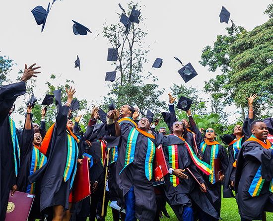 Graduates throwing caps in the air