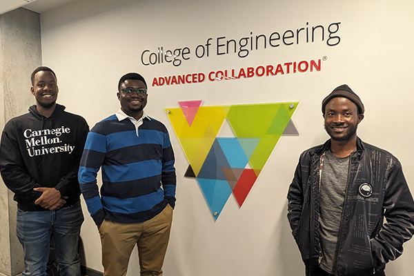 Men standing by Advanced Collaboration sign