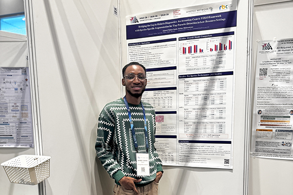 A man standing in front of his poster