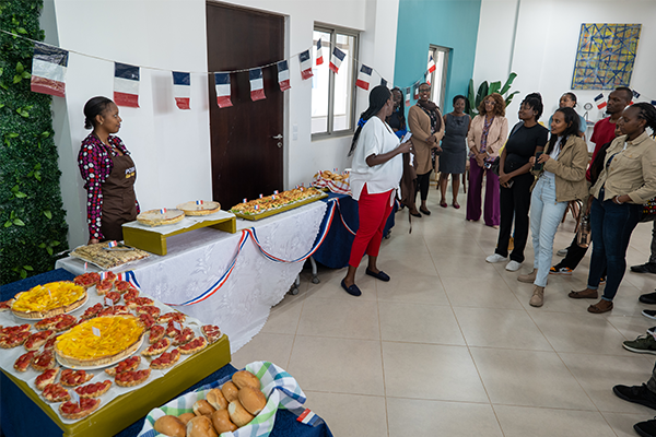 Group standing around tables with food